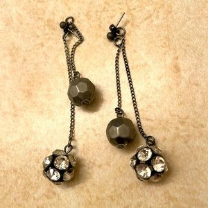 Earrings with two dangling balls. One is a silver metal, other has rhinestones